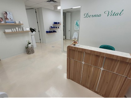 Derma Vital reception desk with Derma Vital logo and product shelves
